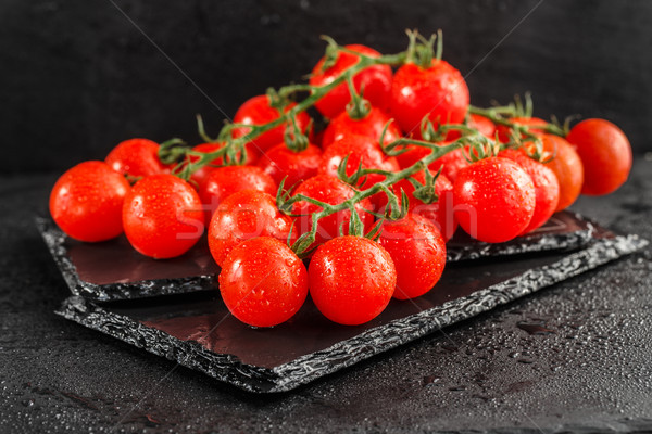 Cherry tomatoes on slate backgound Stock photo © vankad
