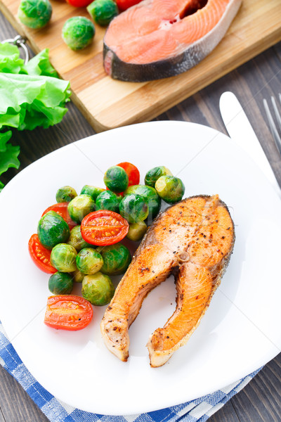 Salmon with roasted brussels sprout and tomato Stock photo © vankad