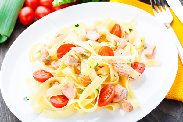 Delicious fettuccini with salmon and tomatoes Stock photo © vankad
