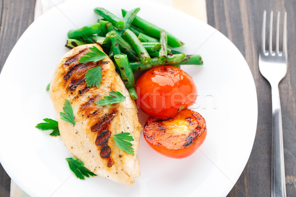 Grilled chicken with green beans and tomatoes Stock photo © vankad