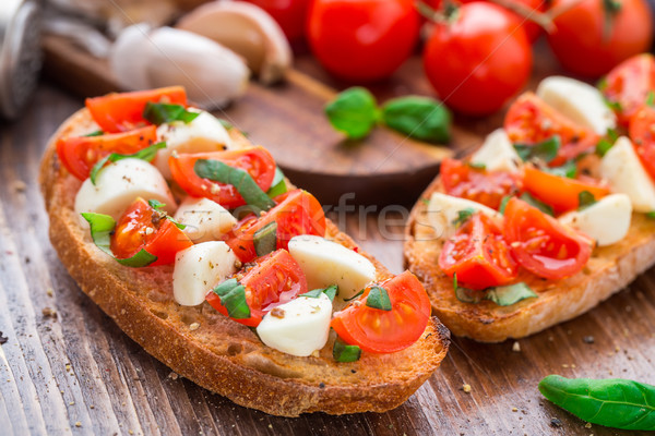 Bruschetta with cherry tomato and mozzarella Stock photo © vankad