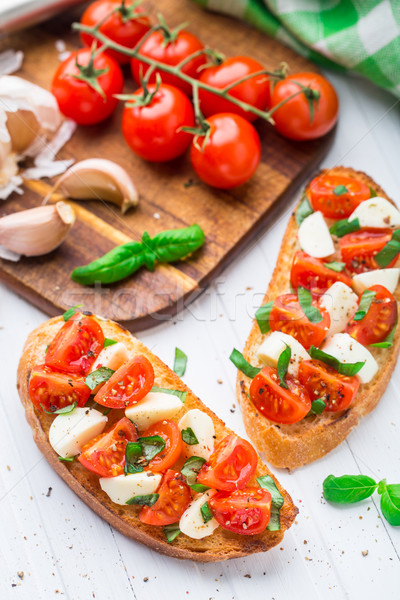 Bruschetta with cherry tomato and mozzarella Stock photo © vankad