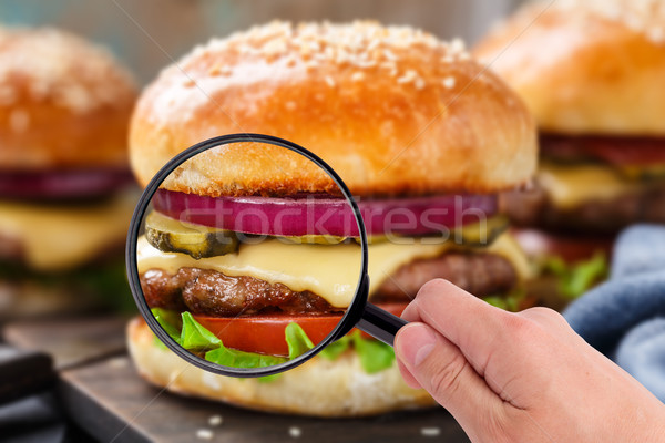 Magnifying glass examining burger  Stock photo © vankad