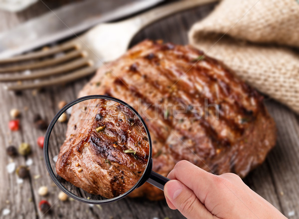 Magnifying glass examining beef steak Stock photo © vankad