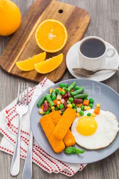 Fish sticks, fried egg and vegetables Stock photo © vankad