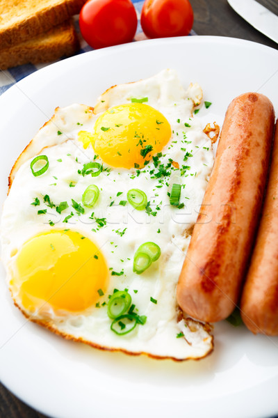 Frit oeufs saucisses plaque orange table [[stock_photo]] © vankad