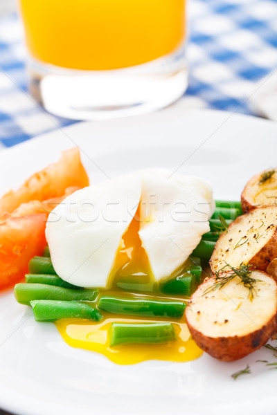 Poached egg with french beans and baked potato Stock photo © vankad