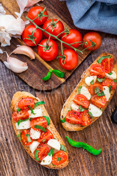 Bruschetta with cherry tomato and mozzarella Stock photo © vankad