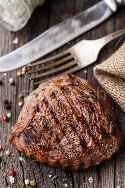 Beef steak on a wooden board Stock photo © vankad