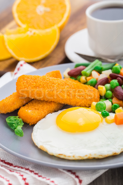 Fish sticks, fried egg and vegetables Stock photo © vankad