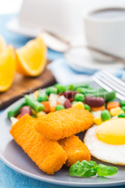 Fish sticks, fried egg and vegetables Stock photo © vankad