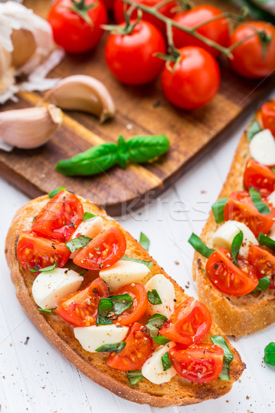 Bruschetta with cherry tomato and mozzarella Stock photo © vankad