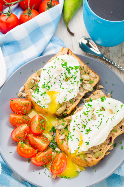 Sandwich with poached egg and cherry tomatoes Stock photo © vankad