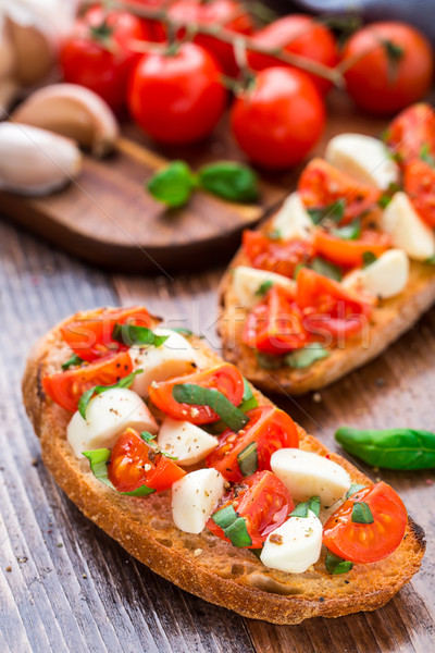 Bruschetta with cherry tomato and mozzarella Stock photo © vankad