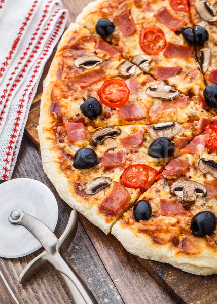 Pizza with ham, mushrooms and olives Stock photo © vankad