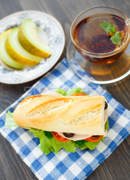 Breakfast with sandwich, tea and melon Stock photo © vankad