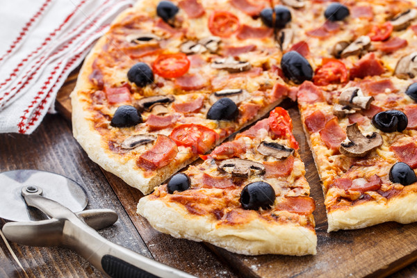 Pizza with ham, mushrooms and olives Stock photo © vankad