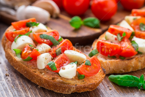 Bruschetta with cherry tomato and mozzarella Stock photo © vankad