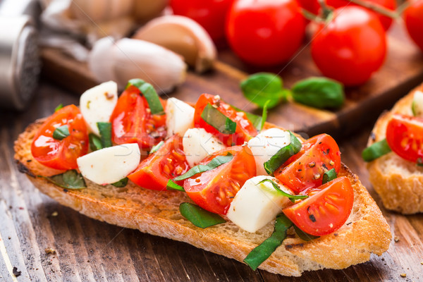 Bruschetta with cherry tomato and mozzarella Stock photo © vankad