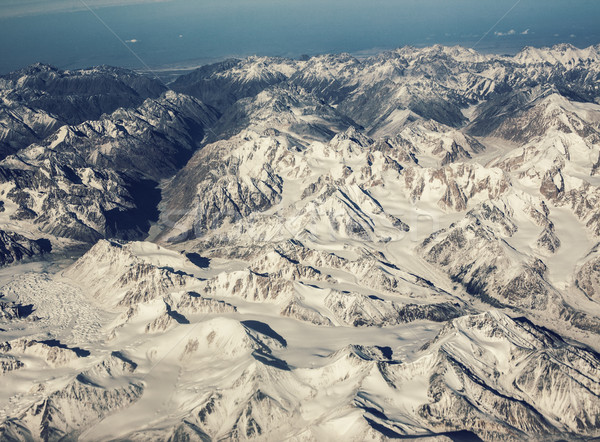 Stock photo: Snowy mountains with a bird's eye. Mountain range of heights