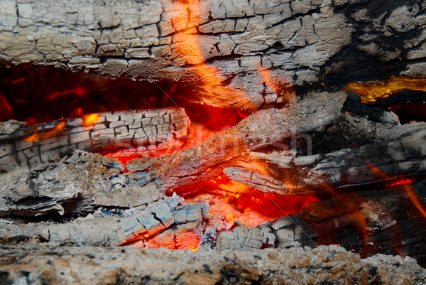 Stock photo: Flame tips on the firewood. 