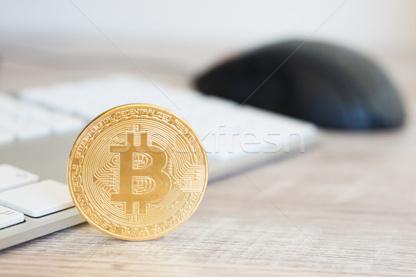 Golden bitcoin on a wooden desk Stock photo © vapi