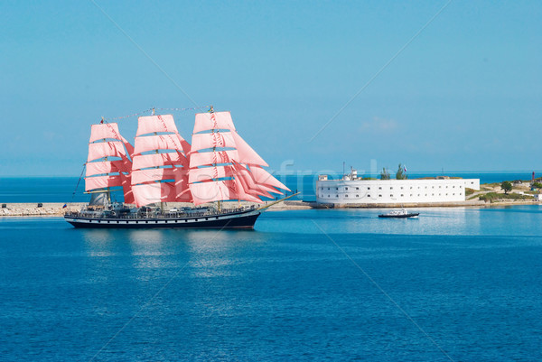 Sailing ship with red sails entering to the bay. Stock photo © vapi