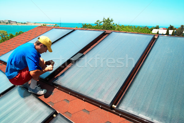 Worker installs solar panels  Stock photo © vapi