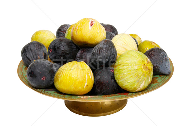 Stack of black and yellow figs on the plate isolated on white. Stock photo © vapi