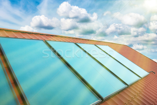 Solar cells on the red house roof Stock photo © vapi