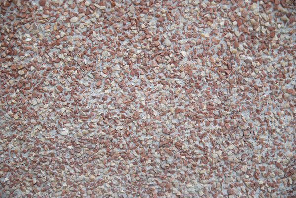A wall of textured natural red stones. Stock photo © vapi