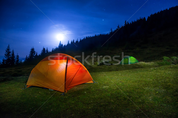 Two Illuminated orange and green camping tents Stock photo © vapi
