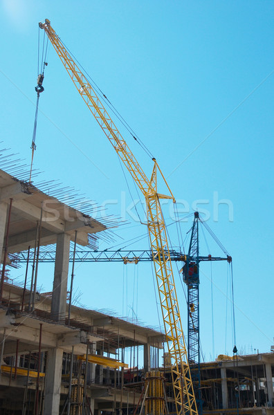Building crane and the building under construction. Stock photo © vapi