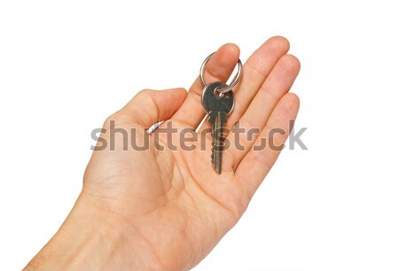 Silver key in a hand isolated on white. Stock photo © vapi