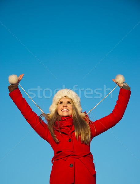 portrait of woman in red coat blue backgound Stock photo © varlyte