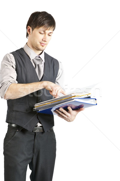 Handsome Young Businessman Looking at Files. Isolated Stock photo © varlyte