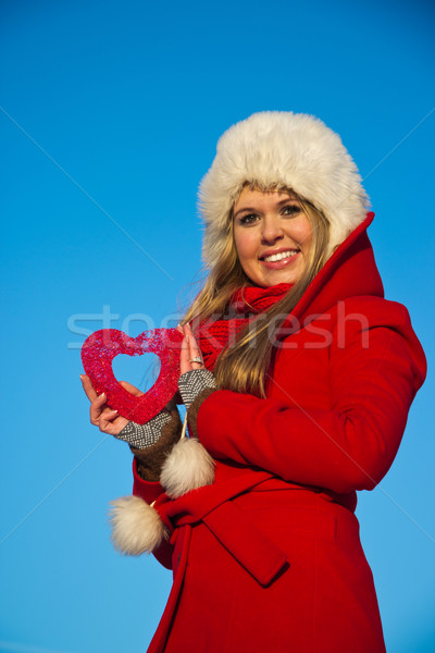 woman in red coat holding heart shape Stock photo © varlyte