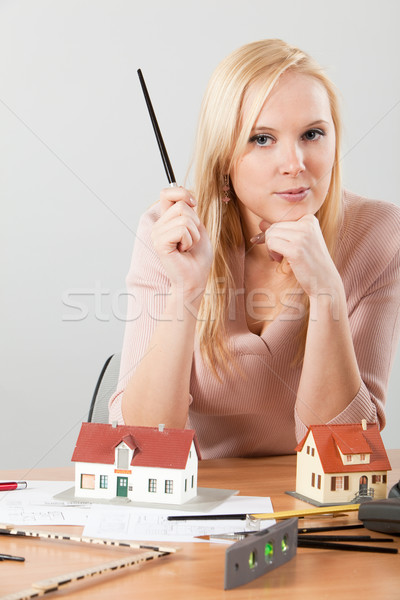 woman architect at her work table exposing house Stock photo © varlyte