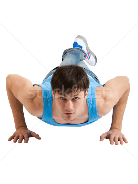 Handsome Young man making push-ups. Isolated Stock photo © varlyte