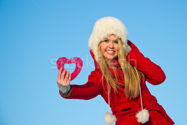 woman in red coat holding heart shape Stock photo © varlyte