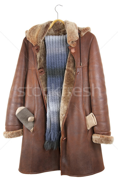 Stock photo: The red leather female coat hangs on a hanger