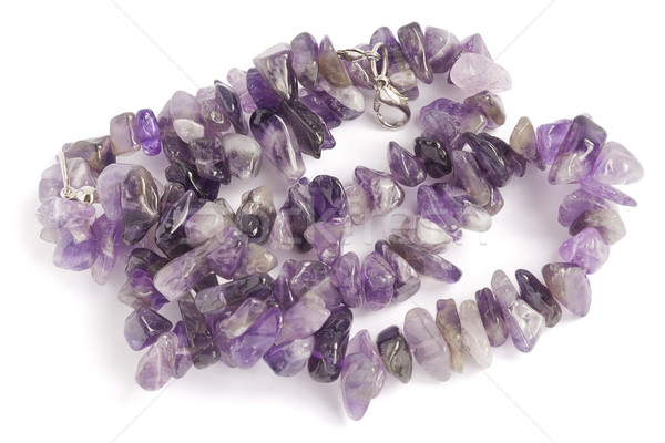 Purple necklace lies on the white velvet Stock photo © vavlt