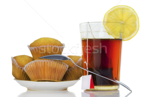 Glass with tea, a lemon and chocolate fruitcakes Stock photo © vavlt