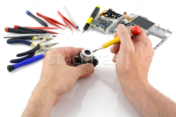 Stock photo: Repair of a lens of the compact camera