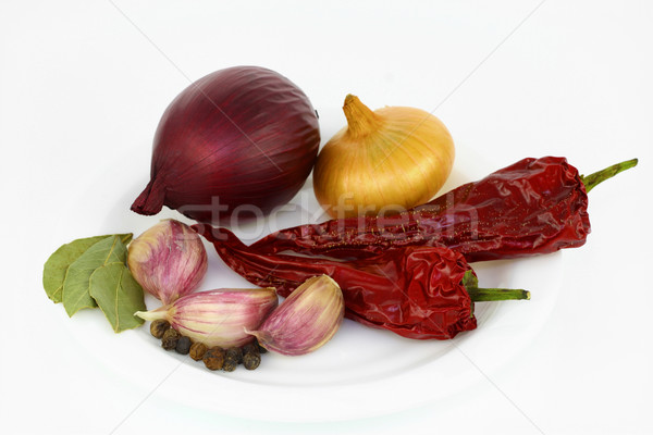 Onions, garlics, peppers, and bay leafs Stock photo © vavlt