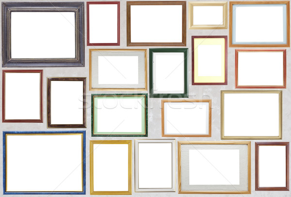 Various wooden photo frames  hang on a wall Stock photo © vavlt