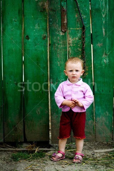 Stock photo: Baby near green fence