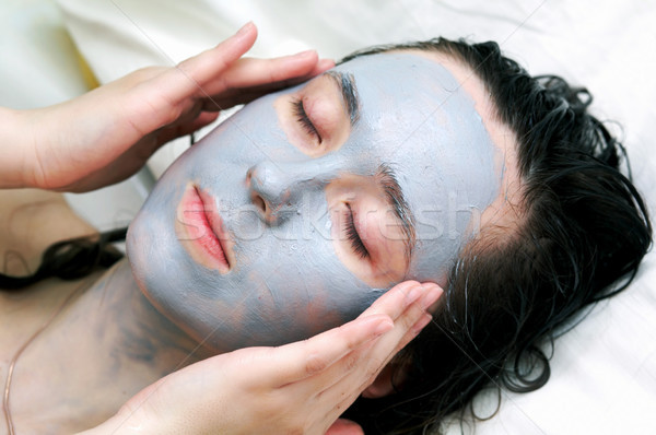 Woman putting a  mask Stock photo © velkol