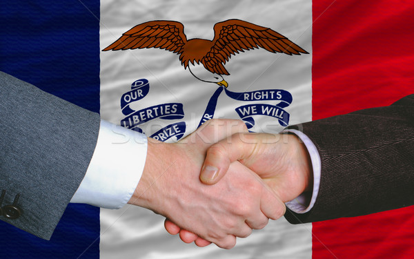 in front of american state flag of iowa two businessmen handshak Stock photo © vepar5