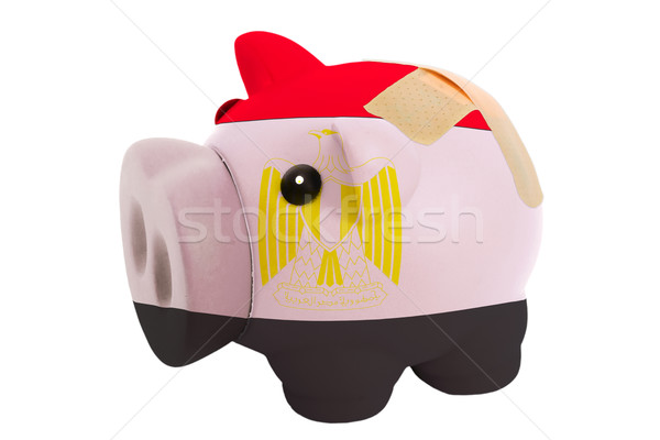 closed piggy rich bank with bandage in colors national flag of e Stock photo © vepar5